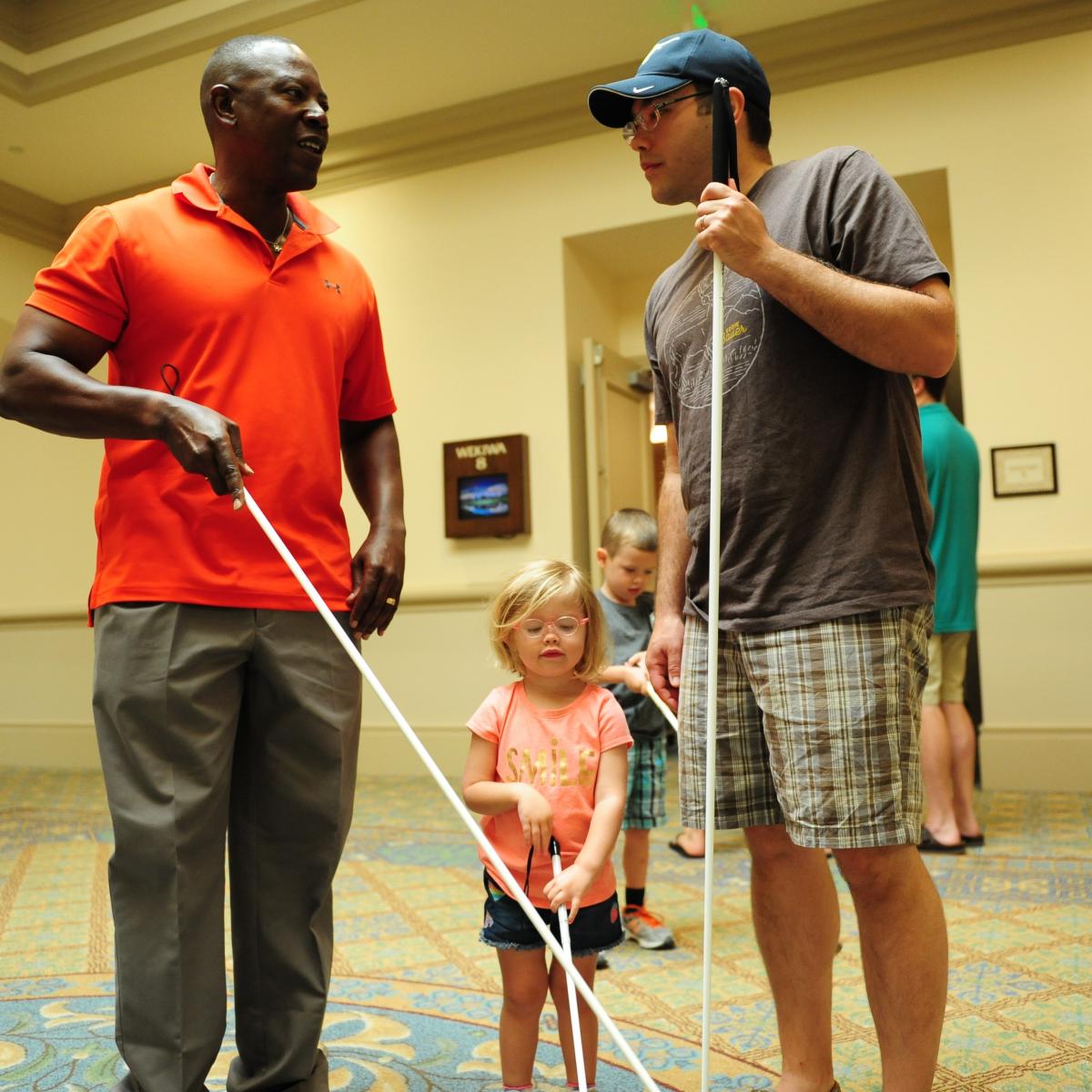 a father and daughter with cane getting a cane travel lesson