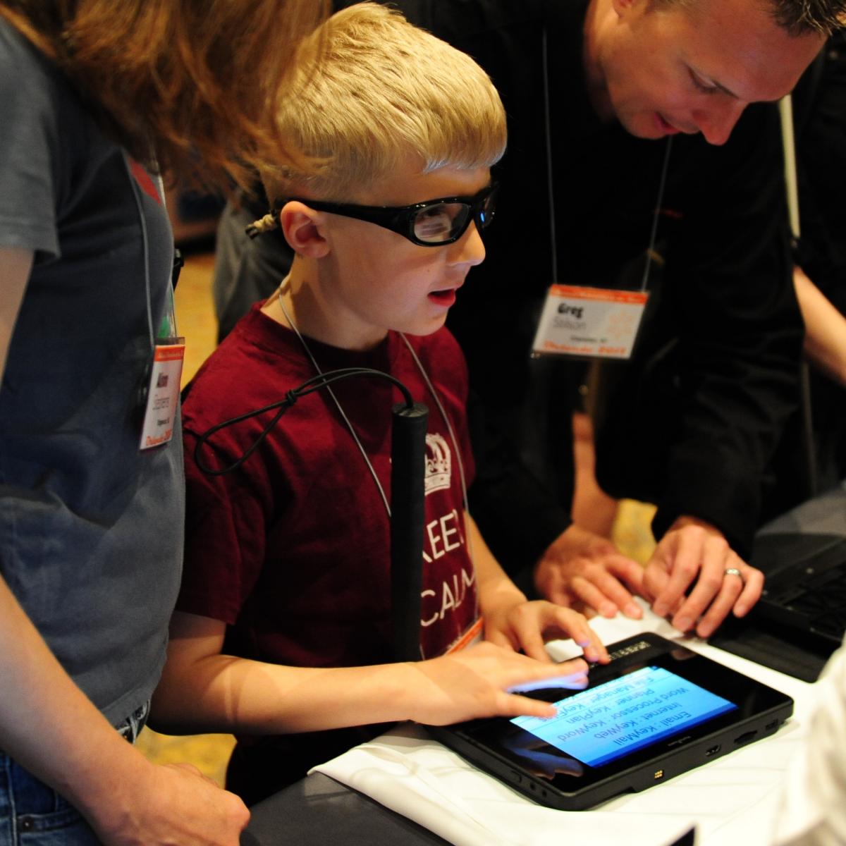 a boy exploring a accessible device 